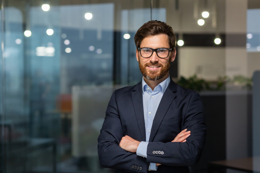 Professional male smiling standing in an office