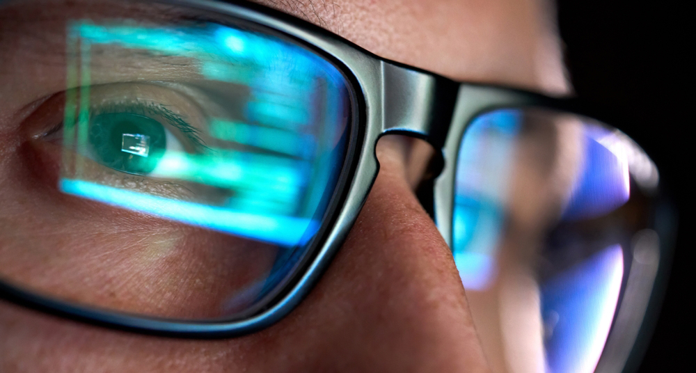 Focused developer looking at code on a computer screeen