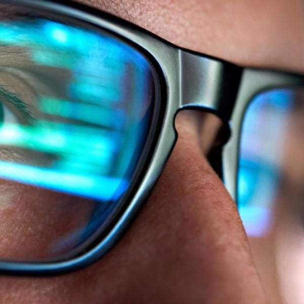 Focused developer looking at code on a computer screeen