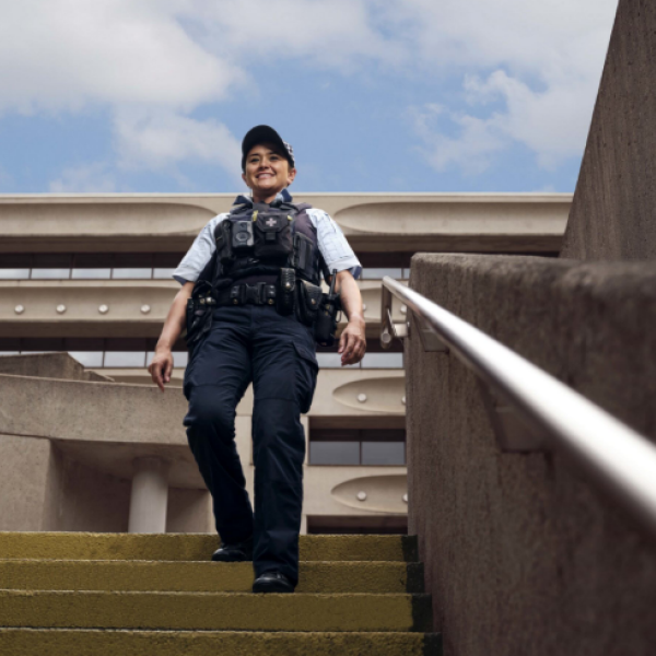 Full uniformed officer walking down stairs