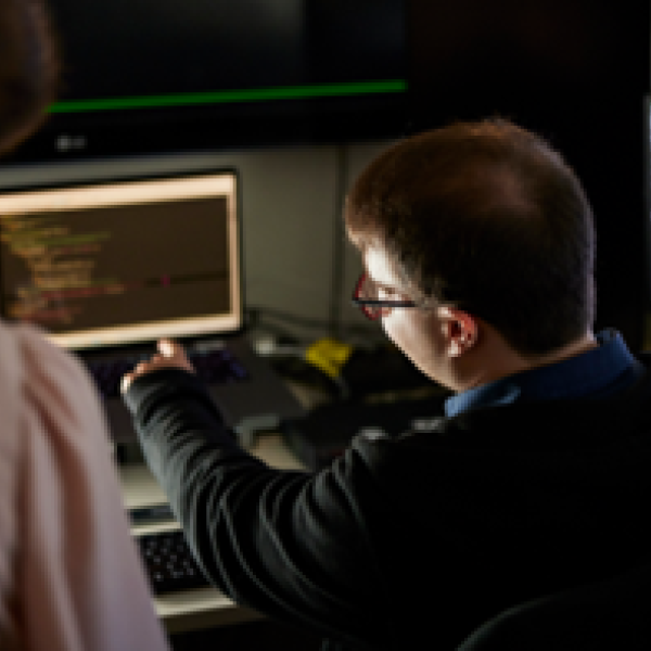 Worker showing colleague data on computer