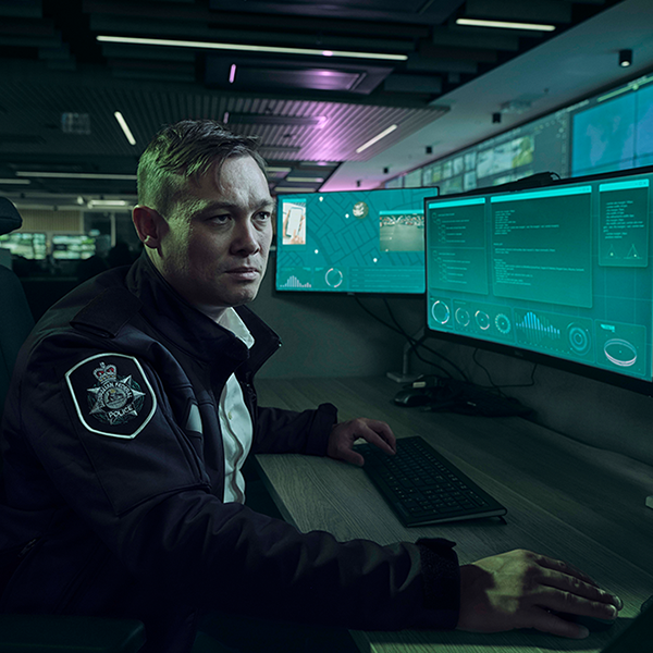 Officer sitting in front of desk in cyber centre