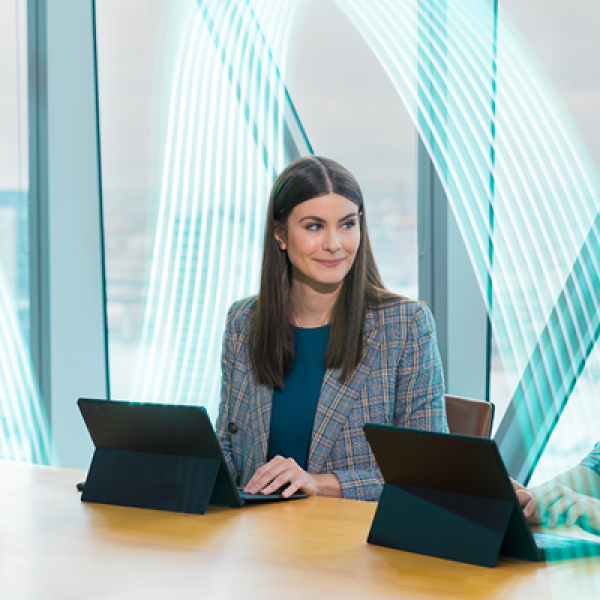 Three people at a conference table meeting