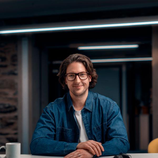 Jake sitting at desk in a meeting room