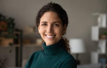 Smiling brunette female in green jumper