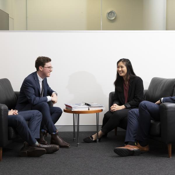 DIO mission assurance staff talking in a group