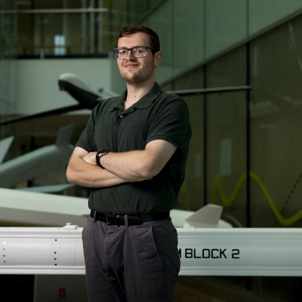 DIO Scientific Intelligence Analyst standing with arms folded