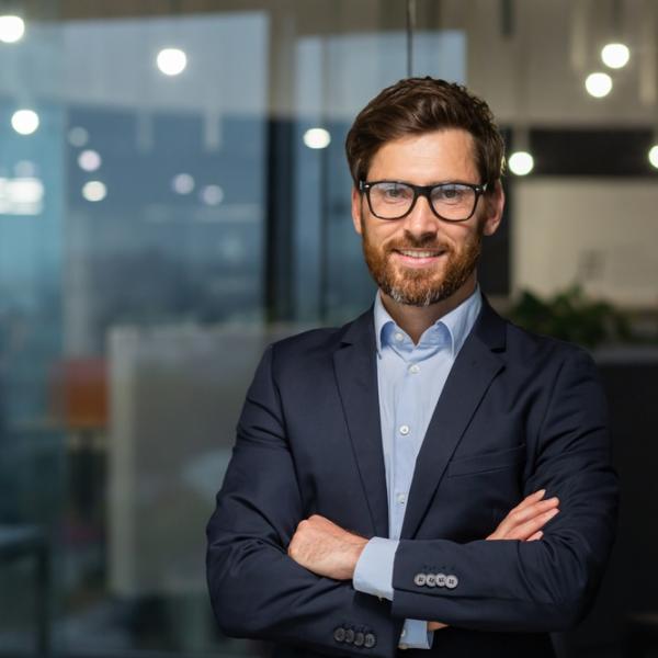 Professional male smiling standing in an office